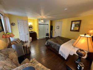 a bedroom with a bed and a desk and a couch at The Gridley Inn B&B in Waterloo