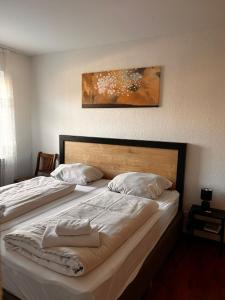 a bedroom with two beds and a picture on the wall at Hotel Rennekamp in Oyten