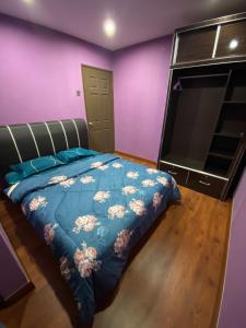 a bedroom with a bed and a flat screen tv at Frosty Hills Homestay in Tanah Rata