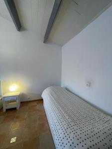 a bedroom with a bed and a side table at Maison de vacances : Bord de mer in Saint-Pierre-dʼOléron