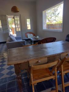 a living room with a large wooden table and chairs at Casa La Cumbre in La Cumbre
