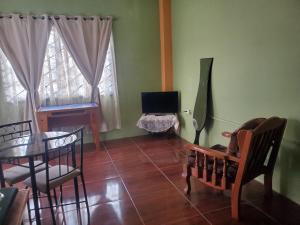 a living room with a table and chairs and a television at OverNite Comfort in Saint Augustine