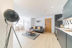 a kitchen and living room with a couch and a table at **Luxury one bedroom flat** in Oxford