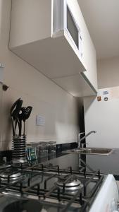 a kitchen with a stove top with a hood at Apartment City Center Recoleta in Buenos Aires