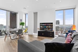 a living room with a couch and a table at Battersea Penthouse Sleep 9 WH in London