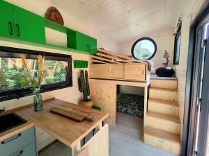 a kitchen with a table in a tiny house at La mini maison du Lama in Libin