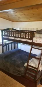two bunk beds are in a room with a ceiling at Mountain Life On Deck in Arnold