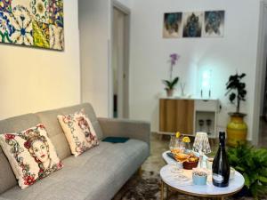a living room with a couch and a table with wine glasses at La Dimora di Anna e Ciccio in Casteldaccia