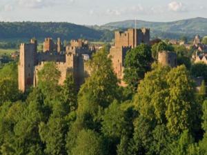 a large castle in the middle of a forest at Pass The Keys Stylish brand new two bedroom house, close to town in Ludlow