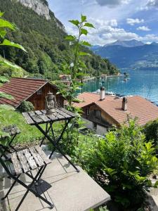 un banco sentado sobre una vista del lago en Bijou Loft - Charming Loft on Lake Thun near Interlaken en Merligen