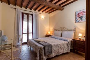 a bedroom with a bed and a window at Podere Cascatelle&Agriletizia - Cascate Naturali in Massa Marittima