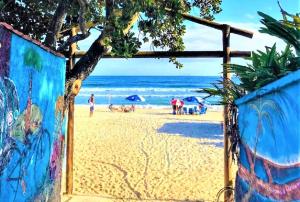 a view of a beach with people on the sand at Apartamento Vista ao Mar Maresias in Maresias