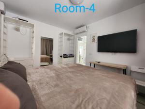 a bedroom with a large bed and a flat screen tv at Villa Blue Lagoon Moraira in Moraira