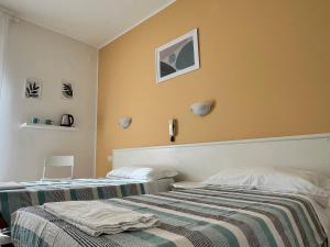 Voodi või voodid majutusasutuse Hotel Parini toas