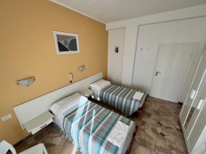 Voodi või voodid majutusasutuse Hotel Parini toas