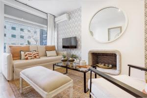 a living room with a couch and a mirror at Genteel Home Retiro in Madrid