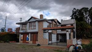 a building with a cross on top of it at Cabaña el Rincon Del Lago in Paipa