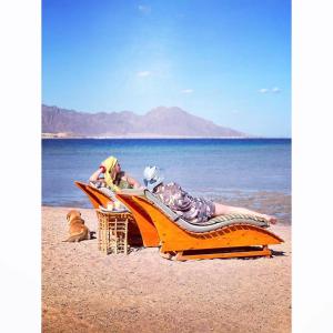 a couple of people laying on the beach at Live the bedouinlife in Nuweiba