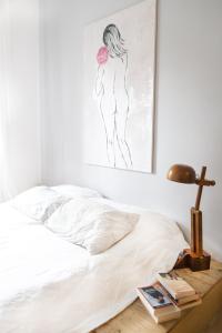 a bedroom with a bed and a painting on the wall at Roma Casal Palocco - Casa dell'artista in Casal Palocco +21 photos