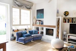 a living room with a blue couch and a fireplace at Roma Casal Palocco - Casa dell'artista in Casal Palocco