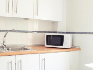 Kuchyňa alebo kuchynka v ubytovaní Fabuloso apartamento junto al Soho con parking privado