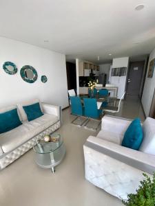 a living room with white furniture and blue pillows at Luxury apartment in Armenia