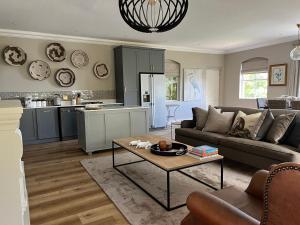 a living room with a couch and a table at Luxury Constantia Apartment in Cape Town