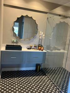 a bathroom with a sink and a mirror at Luxury Constantia Apartment in Cape Town