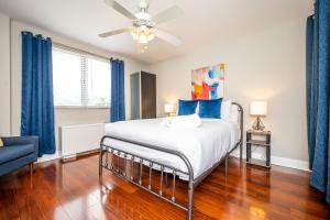 a bedroom with a large bed with blue curtains at ATL Downtown 2BR King Bed Free Parking and Gym LM302 in Atlanta