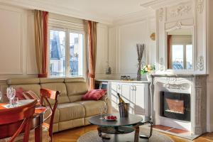 a living room with a couch and a fireplace at 658 Suite Estelle - Luxury appartment in Paris