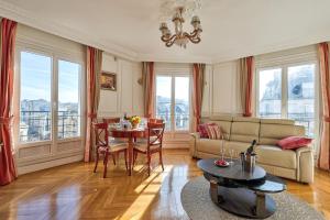 a living room with a couch and a table at 658 Suite Estelle - Luxury appartment in Paris