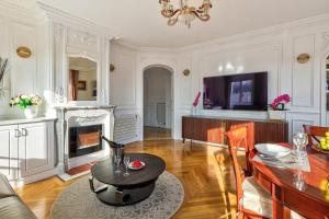 a living room with a table and a fireplace at 658 Suite Estelle - Luxury appartment in Paris