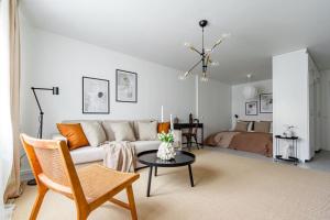 a living room with a couch and a table at Stylish Studio Haven Ideal for Four Guests in Stockholm