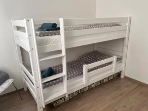 a white bunk bed in a room at Ferienwohnung mit Seeblick - Ossiacher See Gerlitzen in Sattendorf
