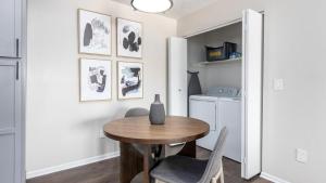 a dining room with a table and a washer and dryer at Landing Modern Apartment with Amazing Amenities (ID9224X56) in Lewis Center