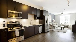 cocina con armarios negros y horno con fogones en Landing Modern Apartment with Amazing Amenities (ID8777X46) en San Diego
