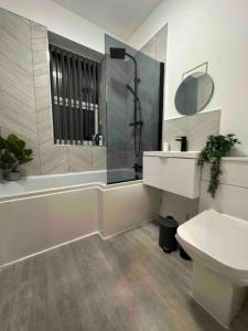 a bathroom with a sink and a shower and a toilet at New Stunning 2-Bedroom Apartment - Sleeps 4 in Bolton