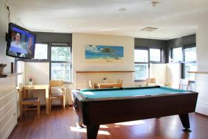 a living room with a pool table and a tv at Bastion Hotel Leiden Voorschoten in Leiden