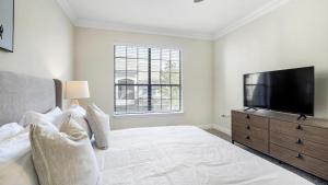 ein Schlafzimmer mit einem großen Bett und einem Flachbild-TV in der Unterkunft Landing Modern Apartment with Amazing Amenities (ID3050X22) in Houston