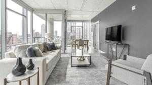 a living room with a couch and a tv at Landing Modern Apartment with Amazing Amenities (ID8152X03) in Chicago