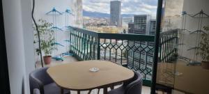a table and chairs on a balcony with a view at Apartment Center Tirana in Tirana