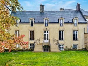 una casa grande con una escalera en el patio en Bayeux, Normandy, Private Mansion, 17th-18th century, in the city en Bayeux