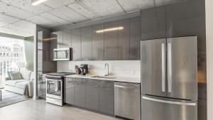 a kitchen with a stainless steel refrigerator and a sink at Landing Modern Apartment with Amazing Amenities (ID8398X77) in Chicago