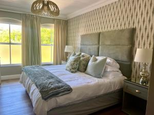 a bedroom with a large bed and a window at Luxury Constantia Apartment in Cape Town