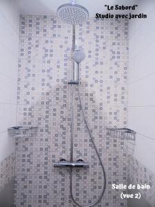 a shower in a bathroom with a shower curtain at Résidence La Hoguette in Saint Malo