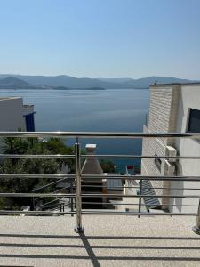 a balcony with a view of a body of water at Apartment First Row in Komarna