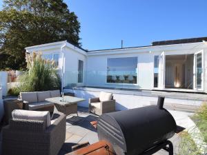 a patio with couches and chairs and a table at 4 Bed in Brixham 76402 in Brixham