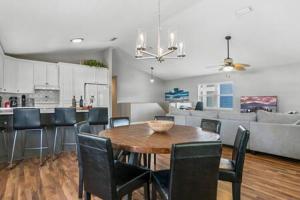 a kitchen and living room with a wooden table and chairs at Casa Comares, Overlooks Lighthouse, Near DT + Bch! in Saint Augustine