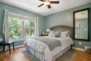 a bedroom with a bed and a large window at Casa Comares, Overlooks Lighthouse, Near DT + Bch! in St. Augustine