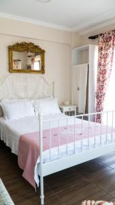 a bedroom with a white bed and a mirror at Ede Apart Otel in Geyikli